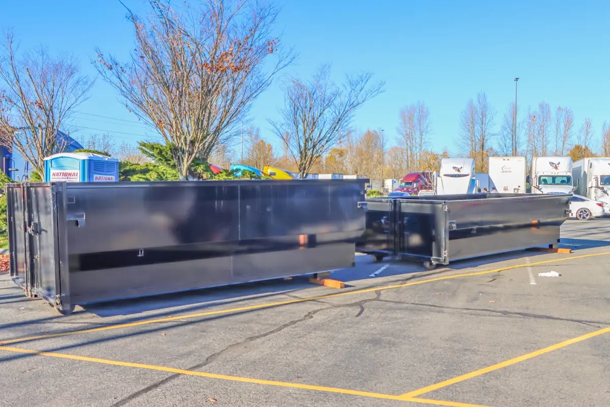 Professional dumpster rental service with roll-off container on residential driveway in Round Lake Park